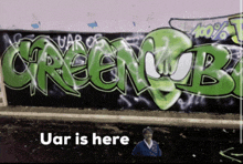 a wall with graffiti on it that says greenmob