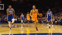 a group of men are playing basketball on a court .