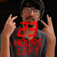 a man wearing glasses and a shirt that says " 23 hours left "