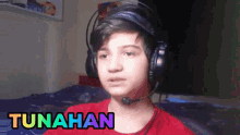 a young boy wearing headphones with the name tunahan on the bottom right