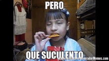 a little girl is eating a piece of food with a meme .