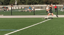 a girl is kicking a soccer ball on a soccer field