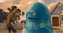 a blue monster with one eye is standing in front of a house .