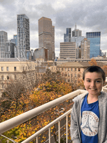 a boy wearing a blue shirt that says paris state