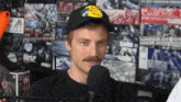 a man with a mustache wearing a bass pro shop hat
