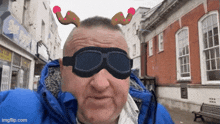 a man wearing a pair of goggles and a reindeer headband