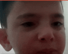 a close up of a boy 's face with a red border around it