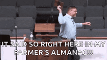 a man is standing in front of a podium in a church holding a book in his hand and dancing .