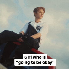 a young man sits on a red and blue vehicle with the words girl who is going to be okay