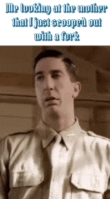 a man in a military uniform is looking at something with a fork