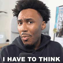 a man in a black hoodie has the words i have to think on his face