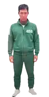 a man is wearing a green tracksuit with the number 456 on his chest