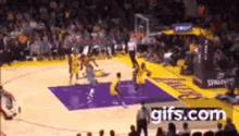 a basketball game is being played in a stadium with a gifs.com ad in the background .