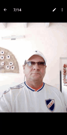 a man wearing a white shirt with a shield that says c.n.d.f.