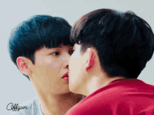 a couple of men kissing with the word offgun on the bottom right