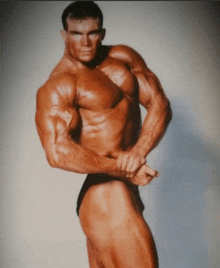 a bodybuilder without a shirt is posing for a photo