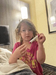 a little girl wearing a pink shirt that says california authentic