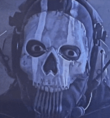 a man wearing a skull mask and headphones looks at the camera