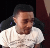 a man wearing a white t-shirt that says when the last time you hugged a girl