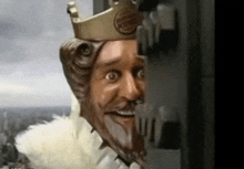 a statue of a man wearing a burger king crown is smiling