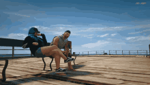 a man and a woman sit on a bench on a dock with mrp in the corner