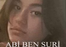 a close up of a woman 's face with the name abi ben suri written below it