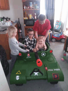 three children are playing in a toy tank that says usa 7429