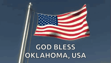 an american flag waving in the wind with the words god bless oklahoma usa