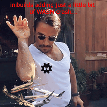 a man wearing sunglasses and a white shirt that says ini on it