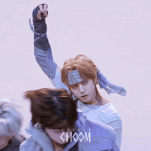 a group of men are dancing in front of a studio choom logo