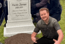 a man is kneeling down in front of a gravestone for kevin james