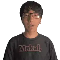 a man wearing glasses and a shirt that says makai on it