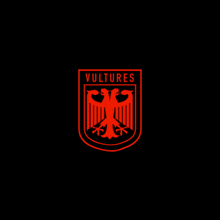 a red and black logo for vultures with an eagle