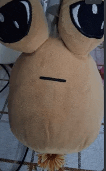 a stuffed animal is sitting on a table and has a hole in it .