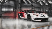 a white and red lamborghini aventador s is parked in a garage .