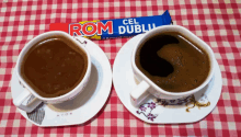 two cups of coffee and a bar of rom dubli