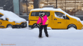 a person standing in front of a nyc taxi