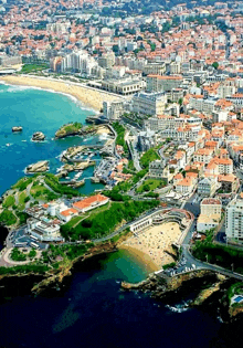 an aerial view of a city with a large body of water surrounding it