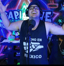 a man wearing a black tank top that says cho en mexico on it