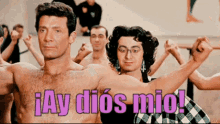 a shirtless man stands in front of a group of people with the words ay dios mio written in pink