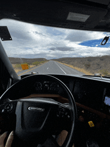 a freightliner truck driving down a highway