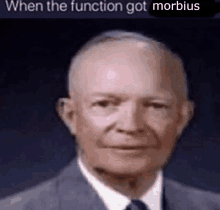 a bald man in a suit and tie is looking at the camera with the caption `` when the function got morbidus '' .