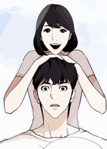 a woman is holding a man 's head with her hands .