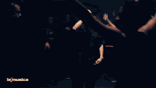 a group of people in a circle with la musica written on the bottom right
