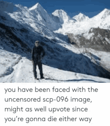 a man is standing on top of a snow covered mountain with mountains in the background .