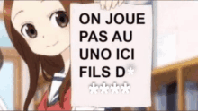 a girl holding a sign that says on joue pas au uno ici fils d