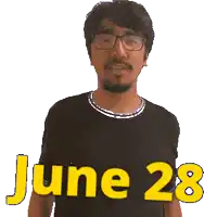 a man wearing glasses and a black shirt says june 28 in yellow letters