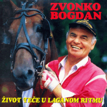 a man standing next to a horse with the name zvonko bogdan on the bottom