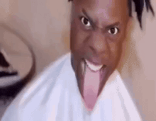 a close up of a man with his tongue out making a funny face .