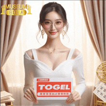 a woman in a white dress is holding a sign that says ' togel ' on it